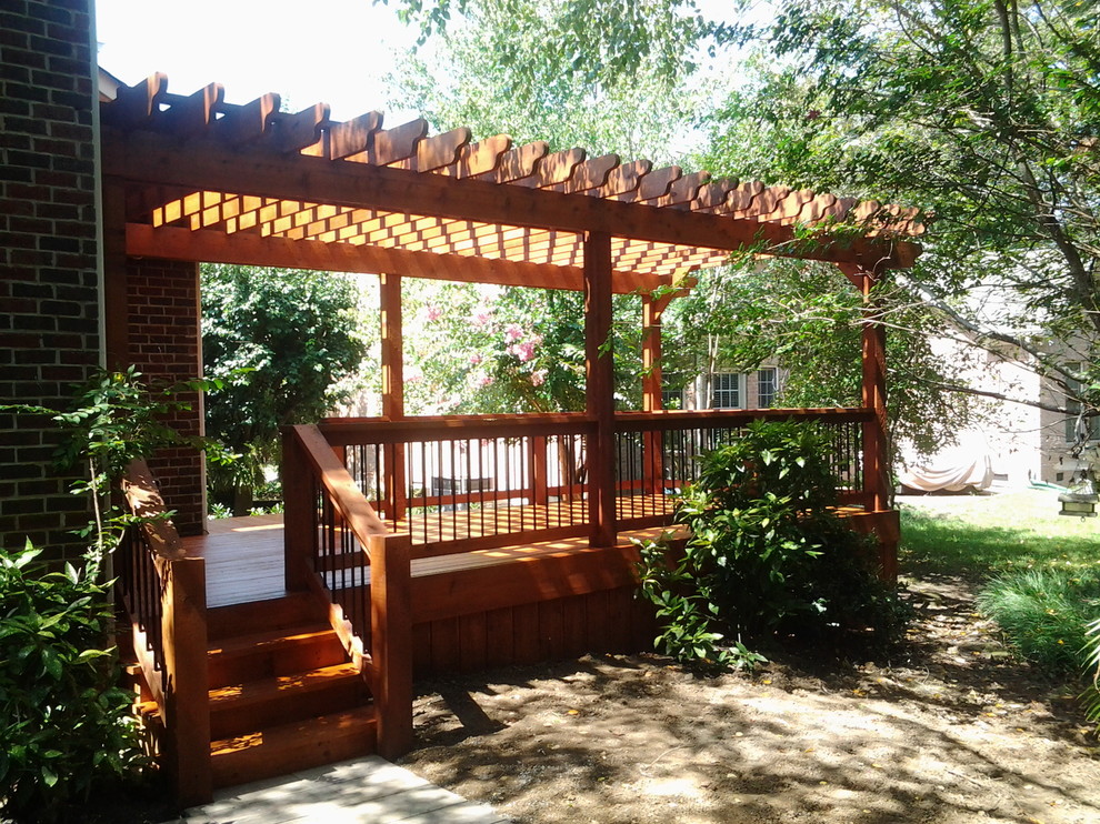 Example of a mid-sized classic backyard deck design in Nashville with a pergola