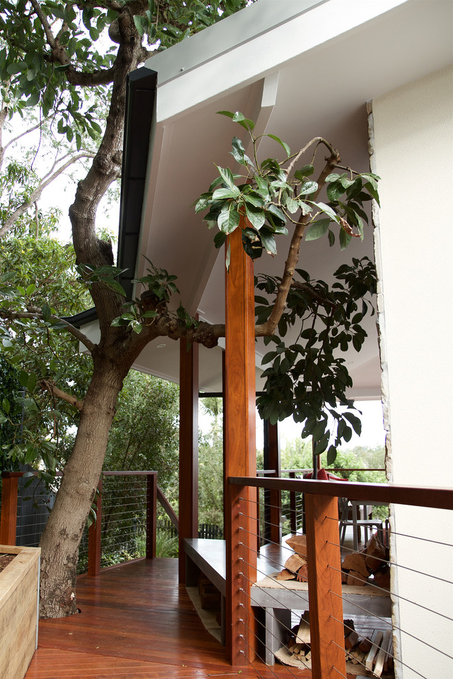 Example of a large trendy deck design in Brisbane with a roof extension
