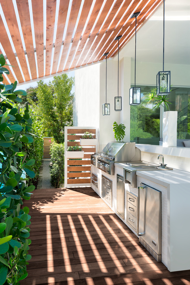 Medium sized coastal side terrace in Miami with an outdoor kitchen and a pergola.