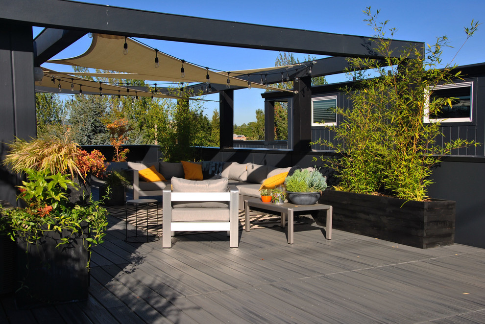 Inspiration for a mid-sized contemporary rooftop deck remodel in Portland with an awning