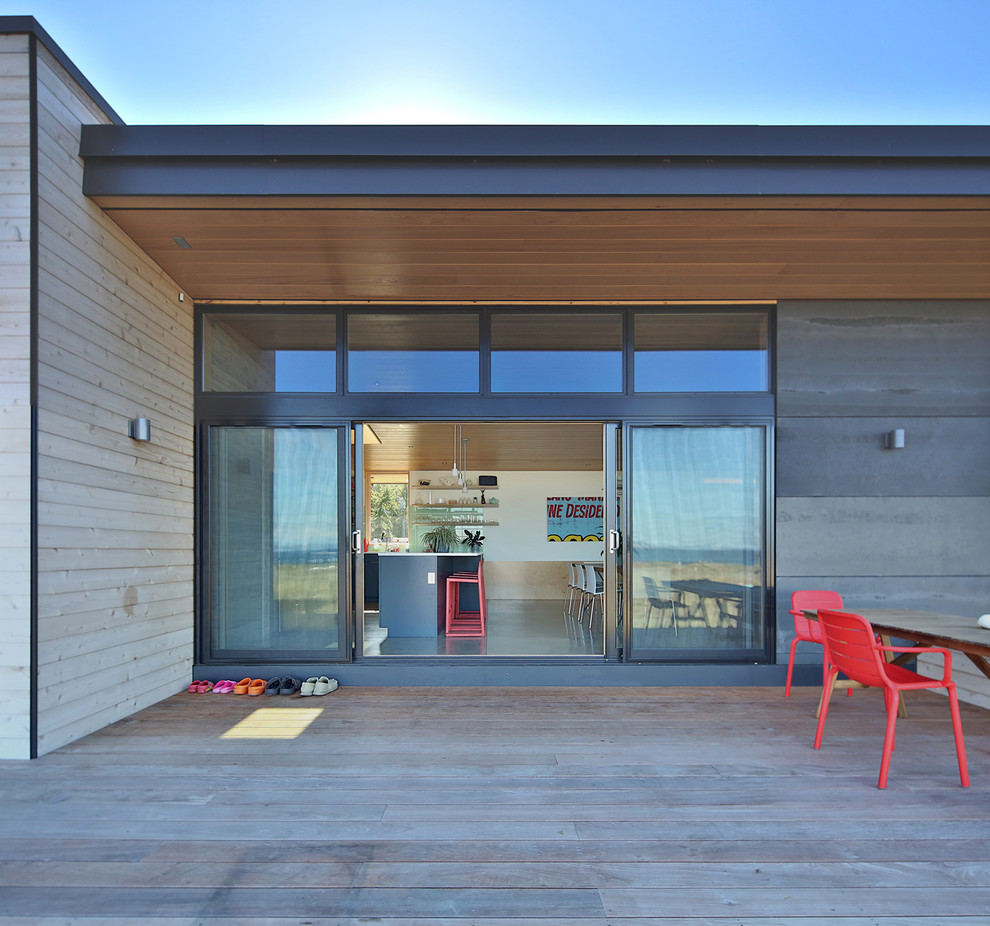 This is an example of a medium sized modern back terrace in Seattle with an outdoor kitchen and a roof extension.
