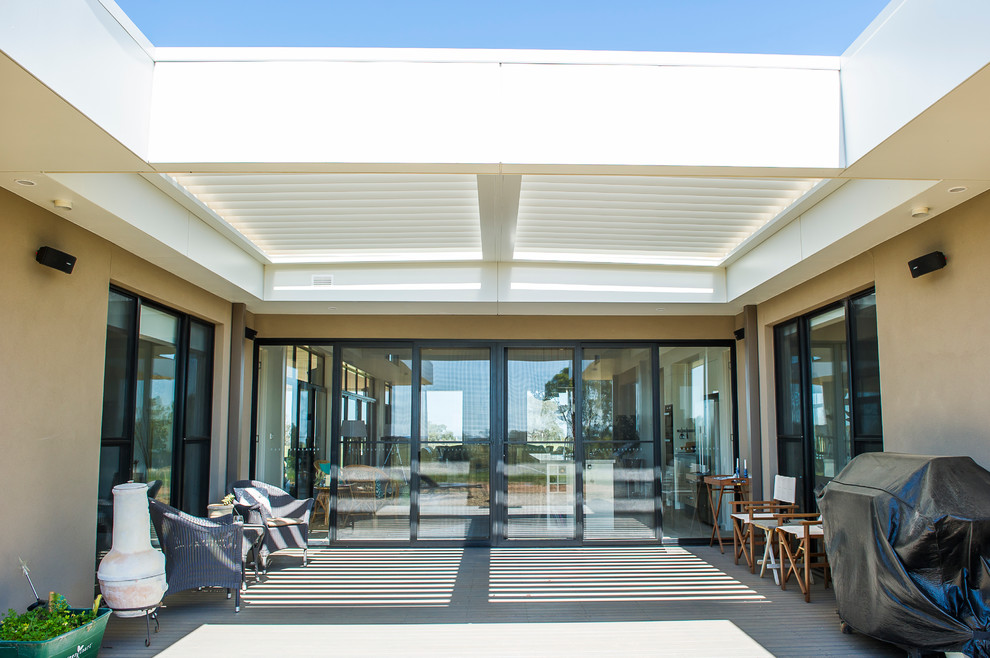 Inspiration for a mid-sized contemporary deck remodel in Sydney with a pergola