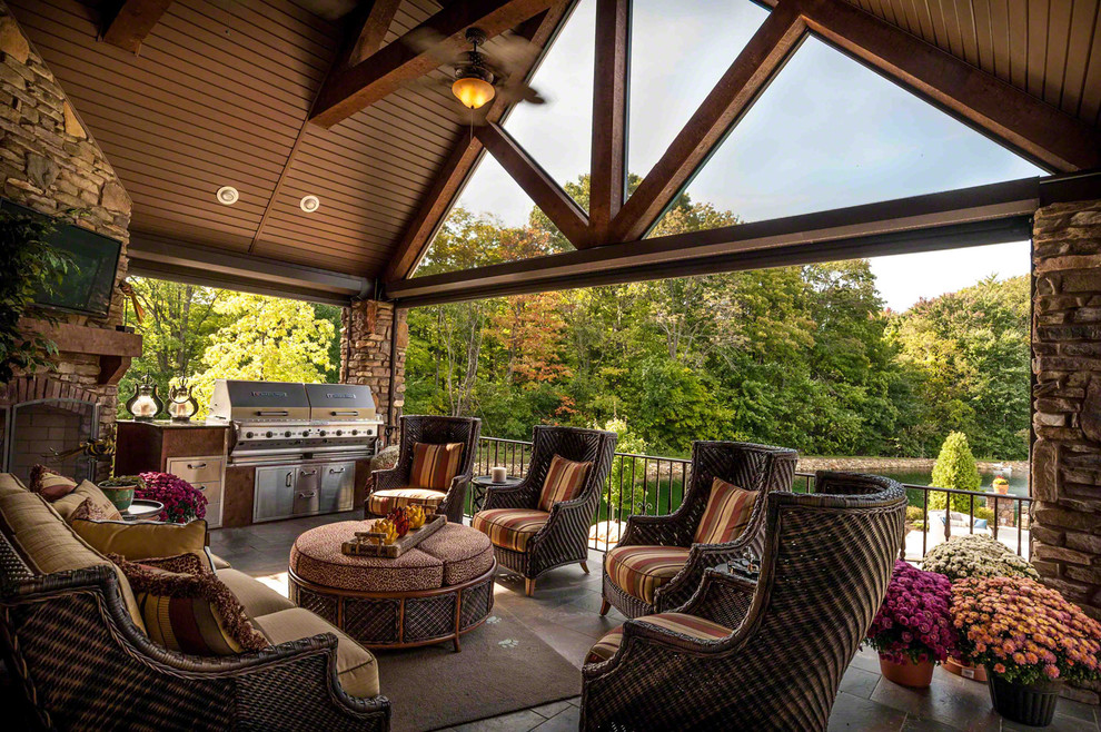 Outdoor kitchen deck - large craftsman backyard outdoor kitchen deck idea in Cleveland with a roof extension