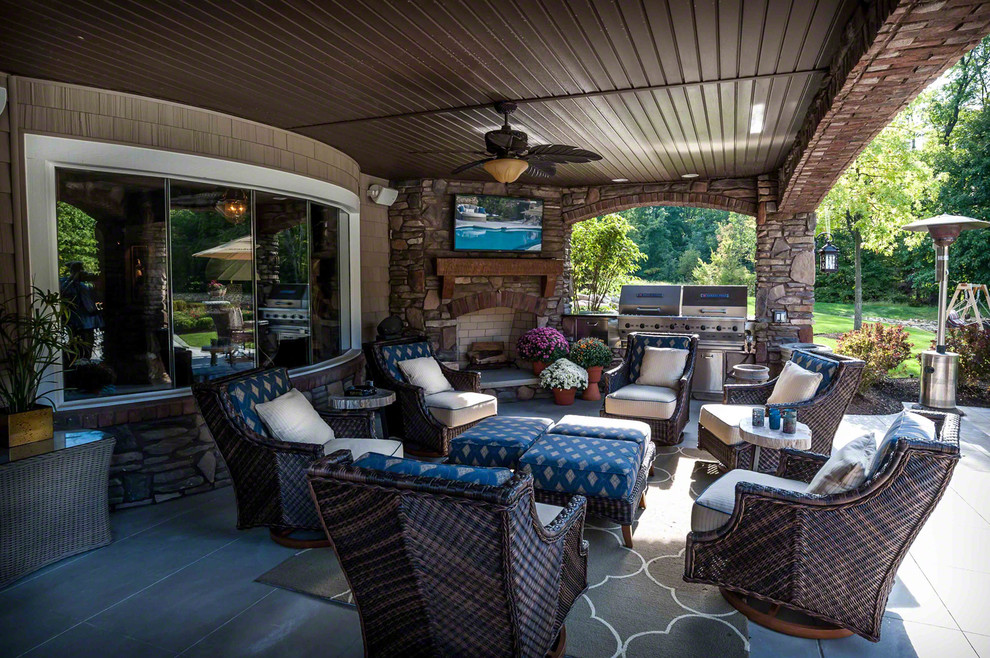Inspiration for a large craftsman backyard outdoor kitchen deck remodel in Cleveland with a roof extension