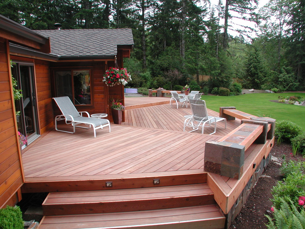 Example of a mid-sized trendy backyard deck design in Seattle with no cover
