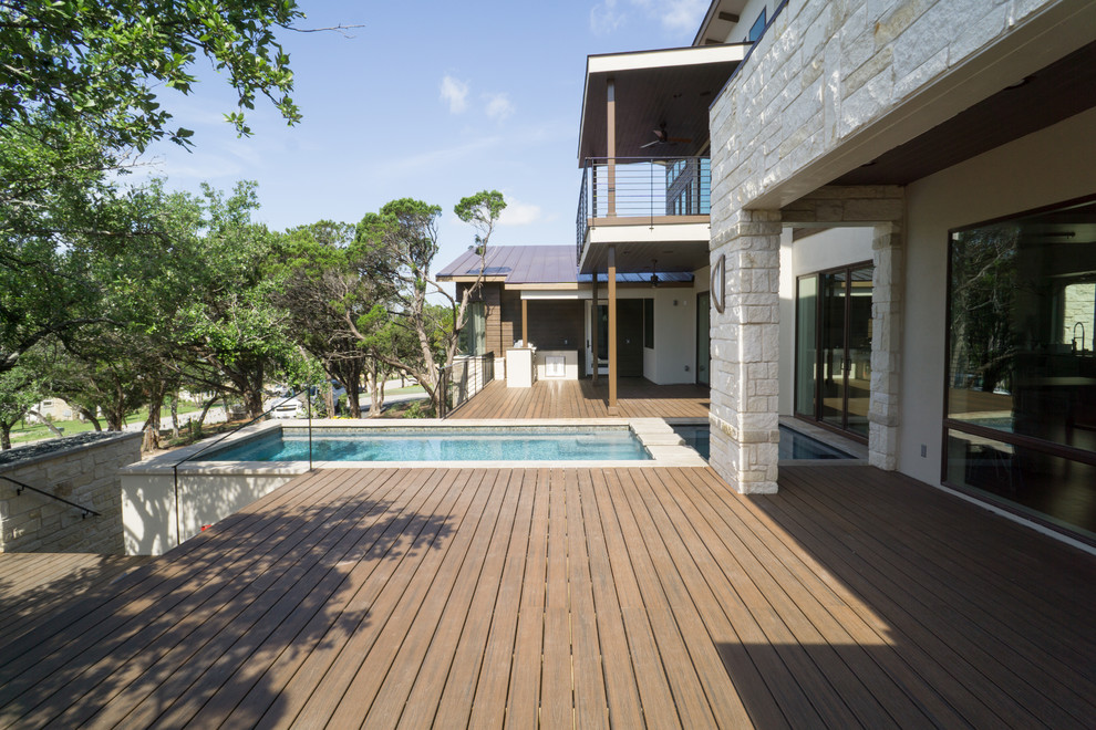 This is an example of a large modern back terrace in Austin with no cover.