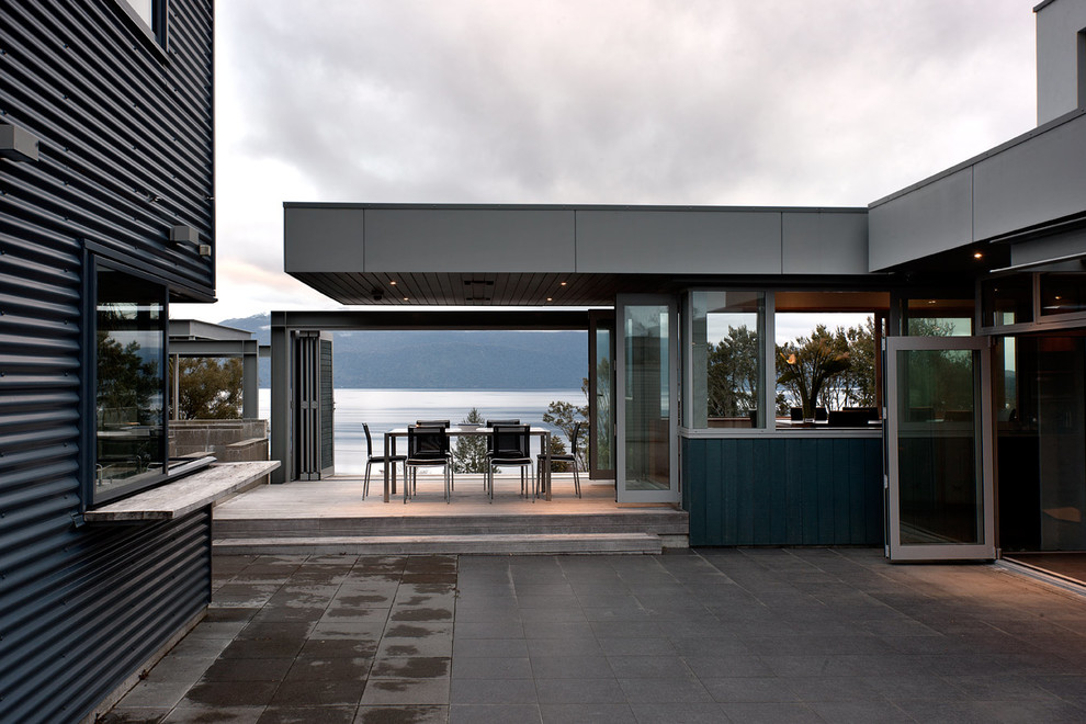 Foto di una terrazza design con un tetto a sbalzo