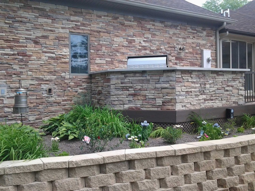 Large classic back terrace in Indianapolis with an outdoor kitchen and no cover.