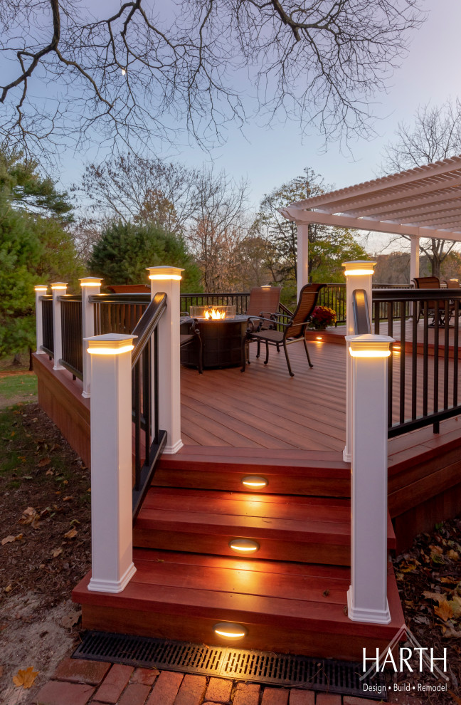 Medium sized traditional back terrace in Philadelphia with a fire feature and a pergola.