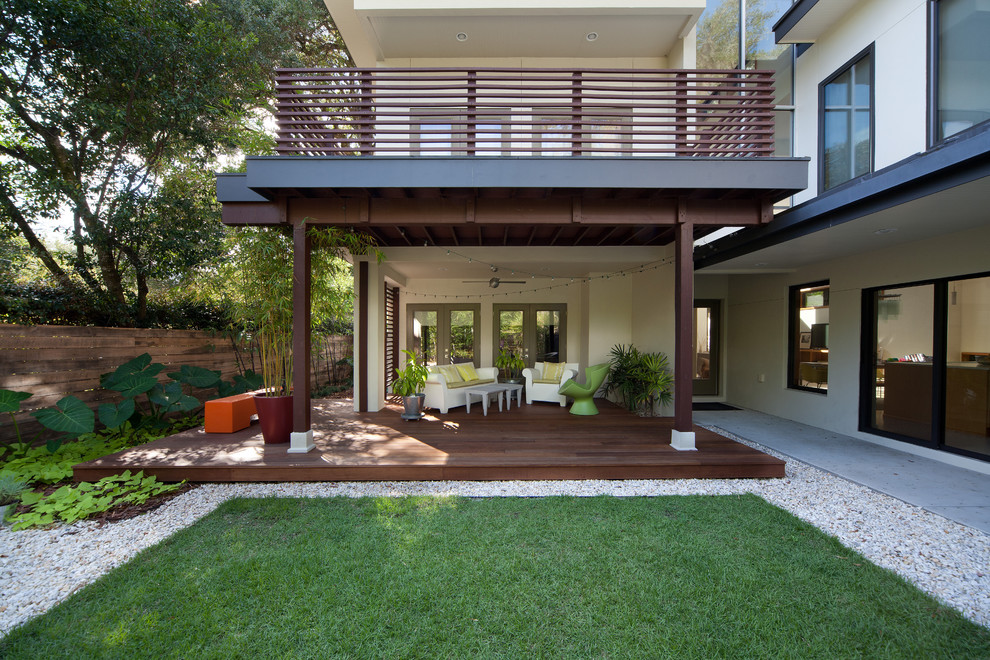 Inspiration for a contemporary deck remodel in Orlando with a roof extension