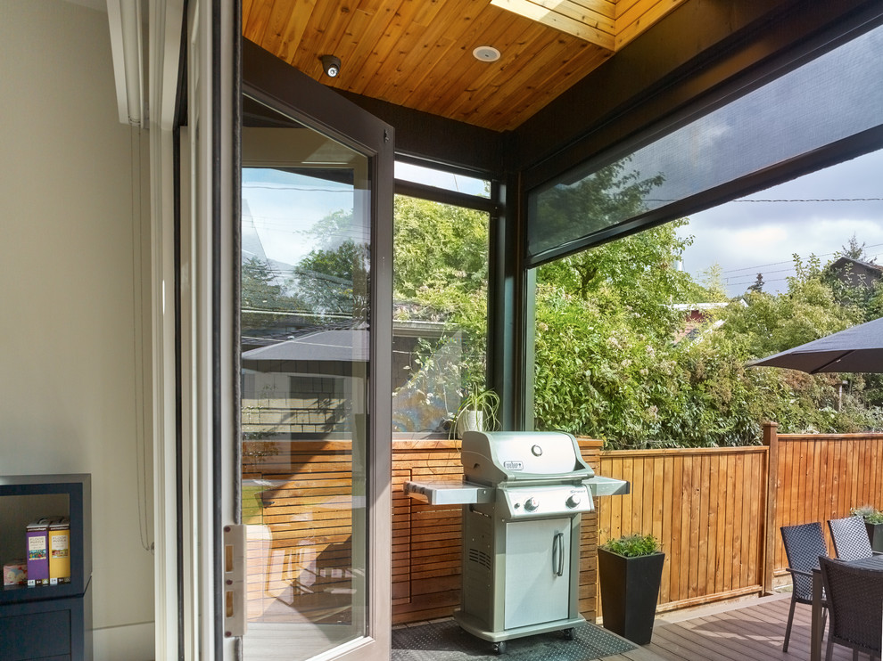 Example of a trendy backyard deck design in Vancouver