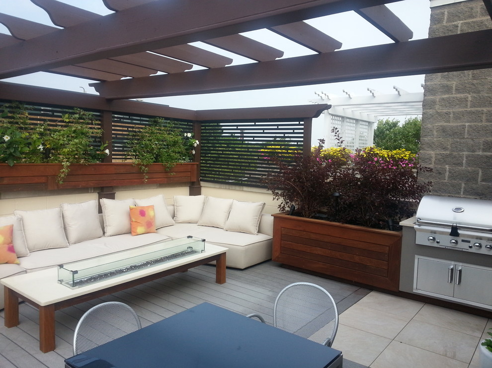Photo of a medium sized contemporary patio in Chicago with a fire feature and a pergola.