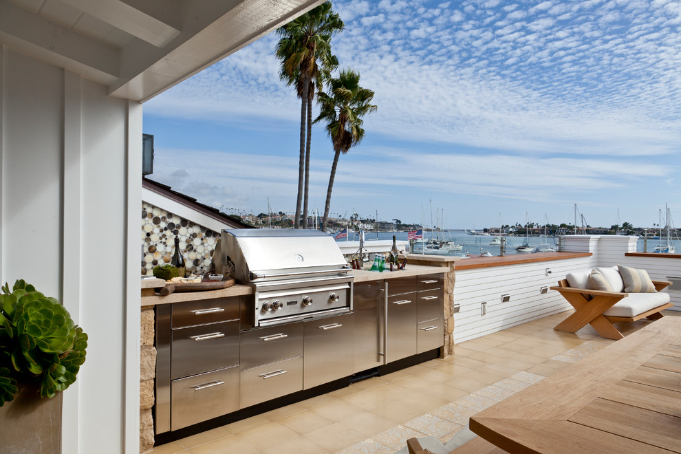 This is an example of a large beach style roof terrace in Orange County with an outdoor kitchen and a roof extension.