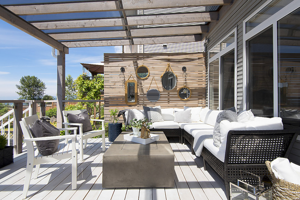 Design ideas for a large mediterranean back terrace in Vancouver with an outdoor kitchen and an awning.