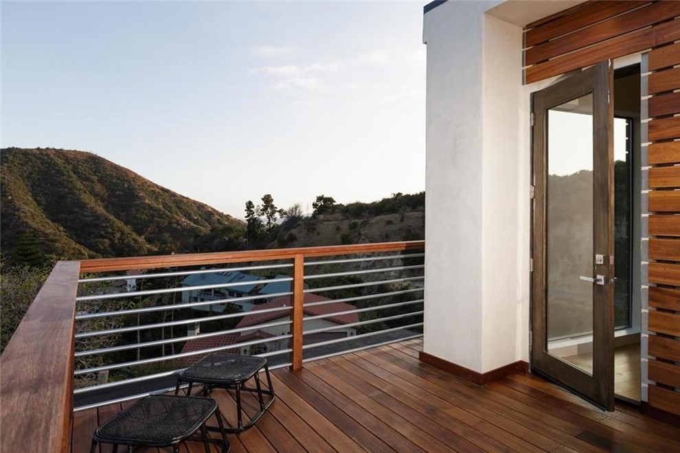 Example of a mid-sized minimalist rooftop deck design in Los Angeles with a pergola