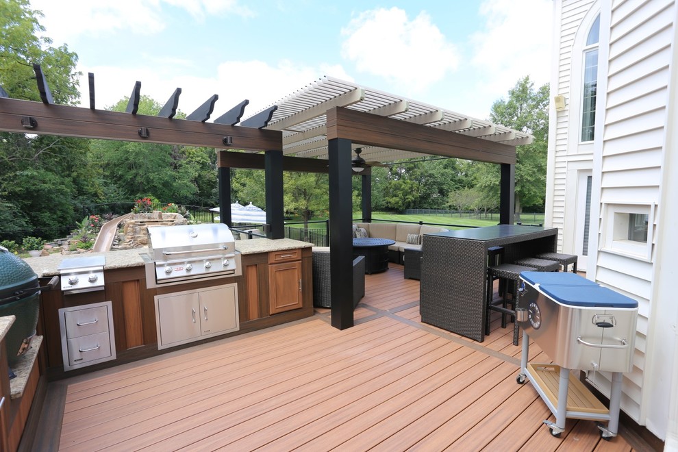 Large contemporary back terrace in St Louis with a pergola.