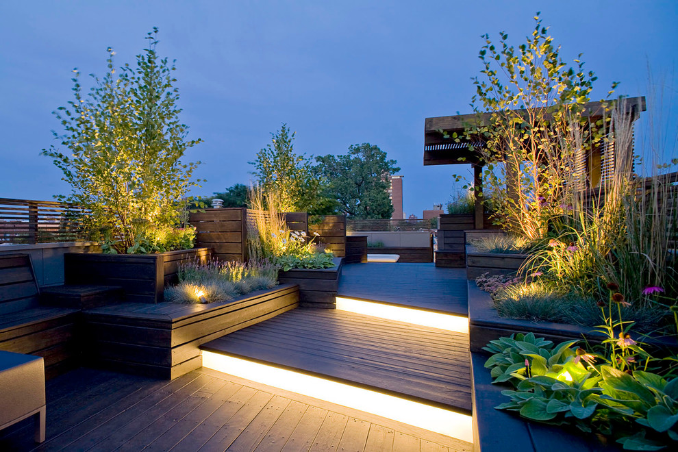 Example of a large trendy rooftop deck design in Chicago with a pergola