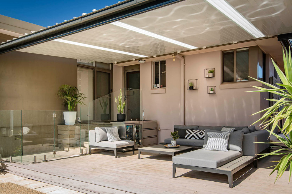 This is an example of a large contemporary back terrace in Canberra - Queanbeyan with an outdoor shower and a pergola.