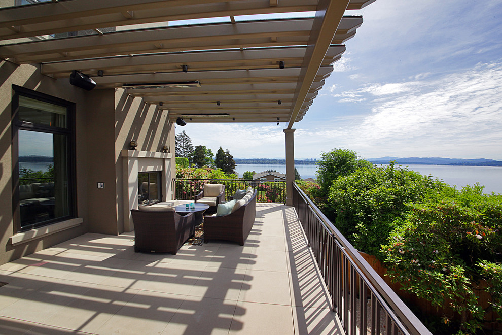 Medium sized contemporary side terrace in Seattle with a fire feature and a pergola.