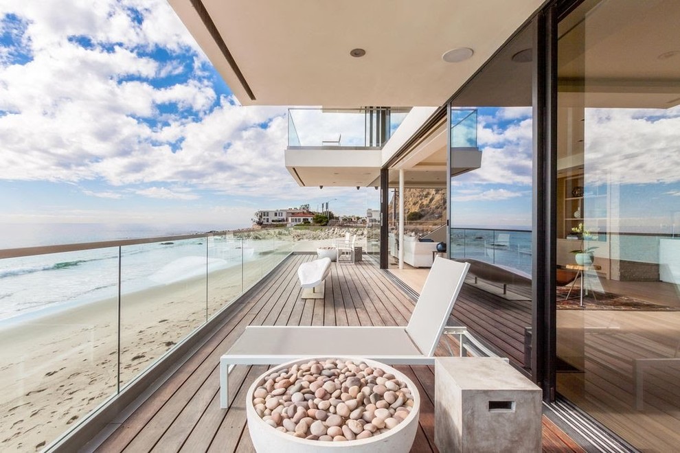 Small beach style glass railing balcony photo in Los Angeles with a fire pit and a roof extension