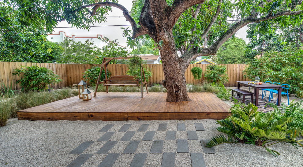 Contemporary back terrace in Miami with no cover.
