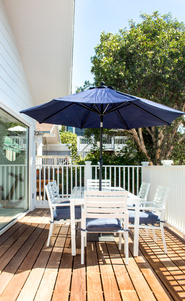 This is an example of a medium sized beach style back terrace in Los Angeles with a roof extension.