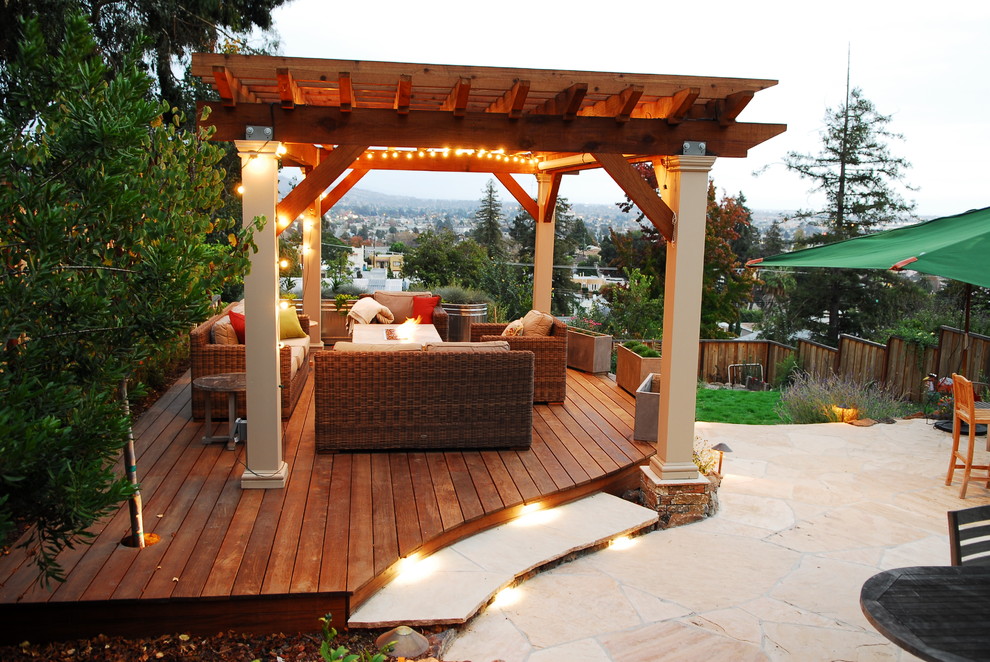 Large eclectic back terrace in San Francisco with a fire feature and a pergola.