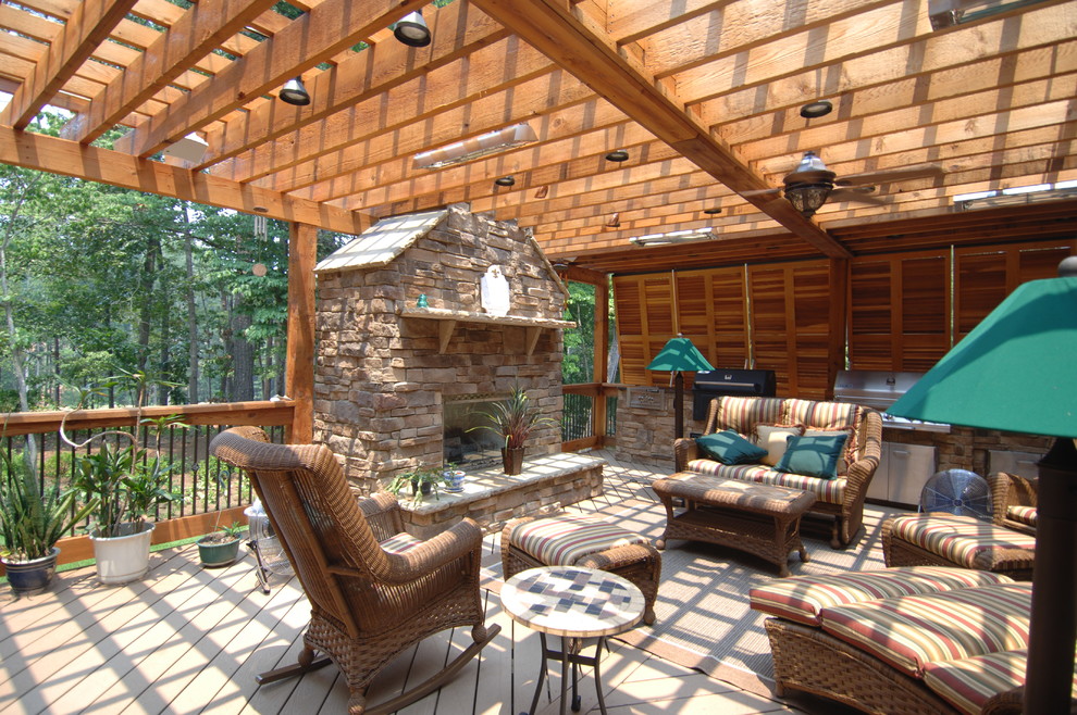 Outdoor kitchen deck - huge rustic backyard outdoor kitchen deck idea in Atlanta with a pergola