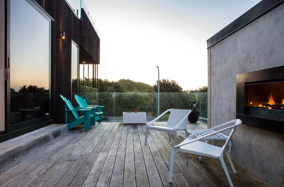 Deck - contemporary rooftop rooftop deck idea in Auckland with a fireplace and no cover
