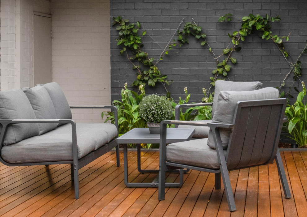 This is an example of a medium sized contemporary back ground level terrace with no cover.