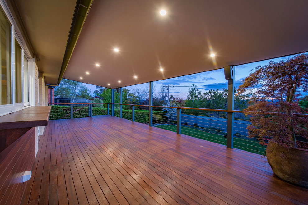 Example of a trendy backyard outdoor kitchen deck design in Canberra - Queanbeyan with a pergola