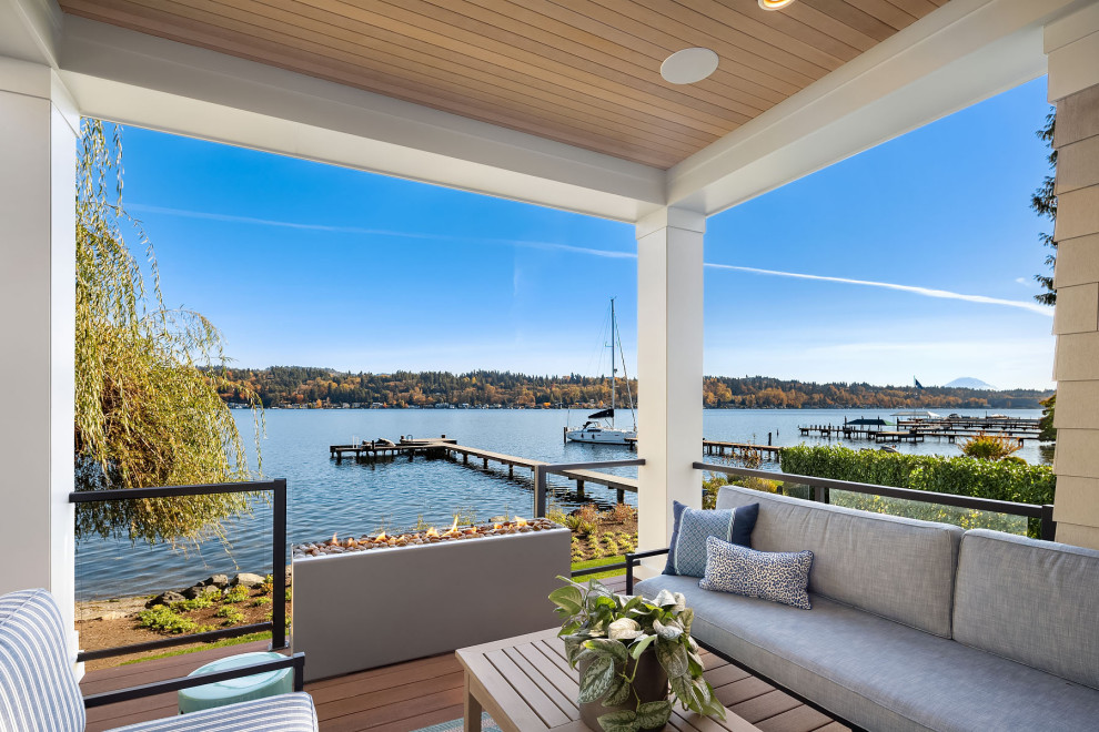 Photo of an expansive nautical back terrace in Seattle with a fireplace and a roof extension.