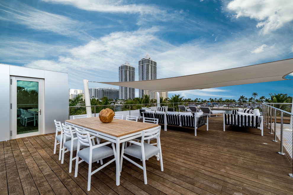 Inspiration for a nautical roof rooftop terrace in Miami with an awning.