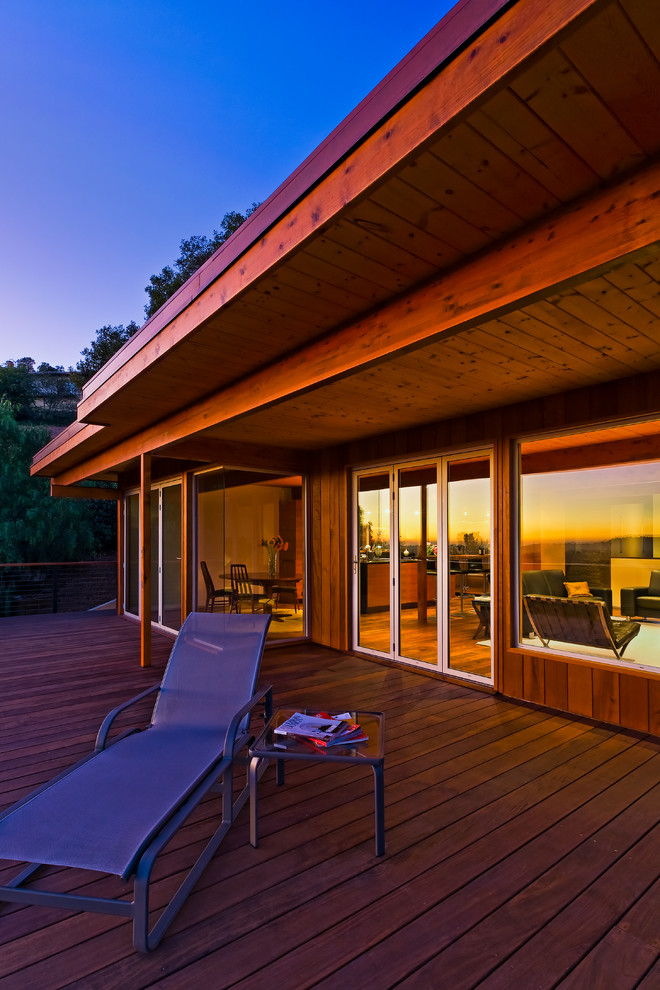 Inspiration for a large midcentury back terrace in Santa Barbara with a roof extension.
