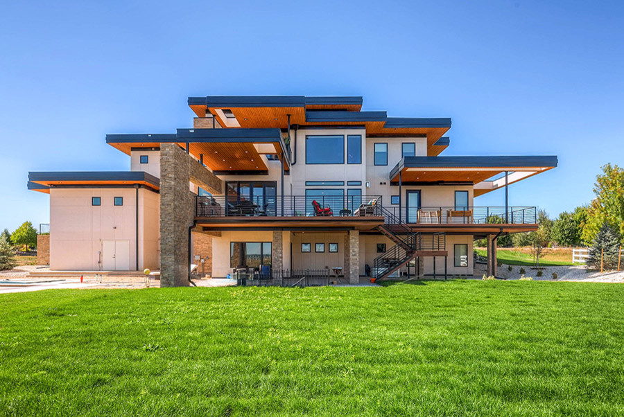 Inspiration for a huge transitional deck remodel in Denver with a roof extension