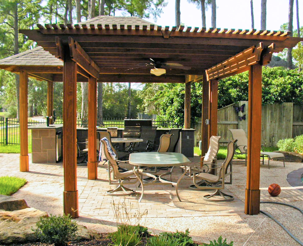 Exemple d'une grande terrasse arrière méditerranéenne avec une cuisine d'été et une pergola.