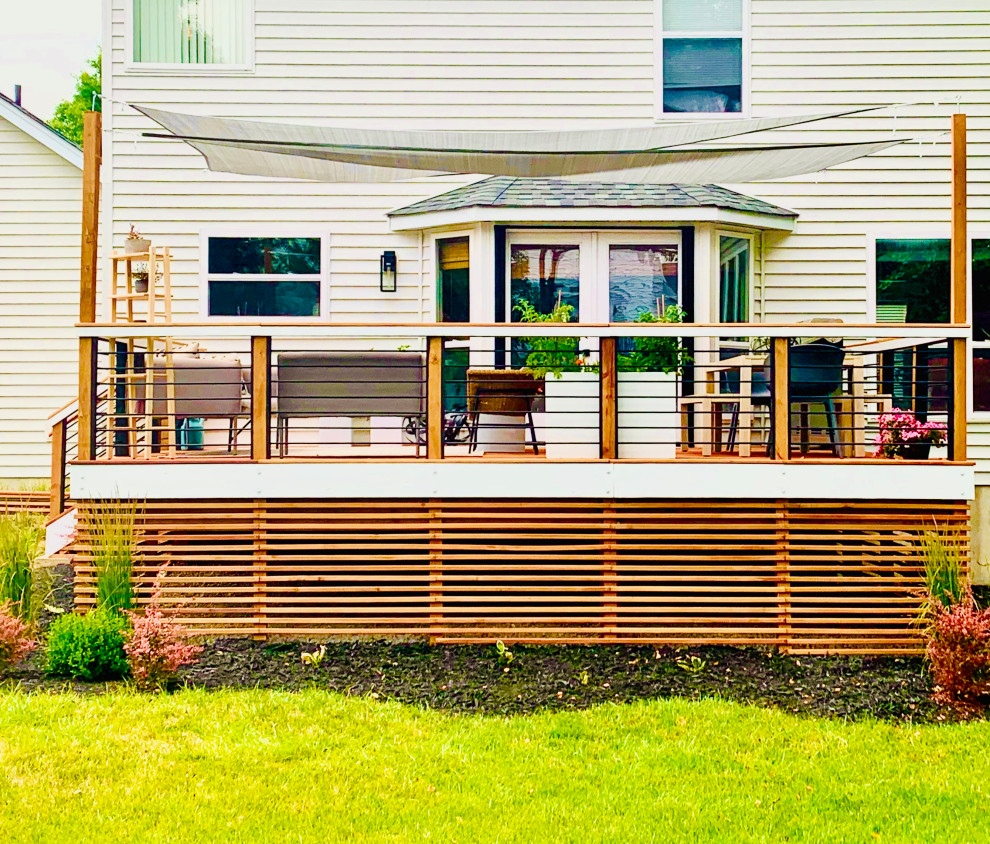 Foto de terraza minimalista grande en patio trasero con brasero y toldo
