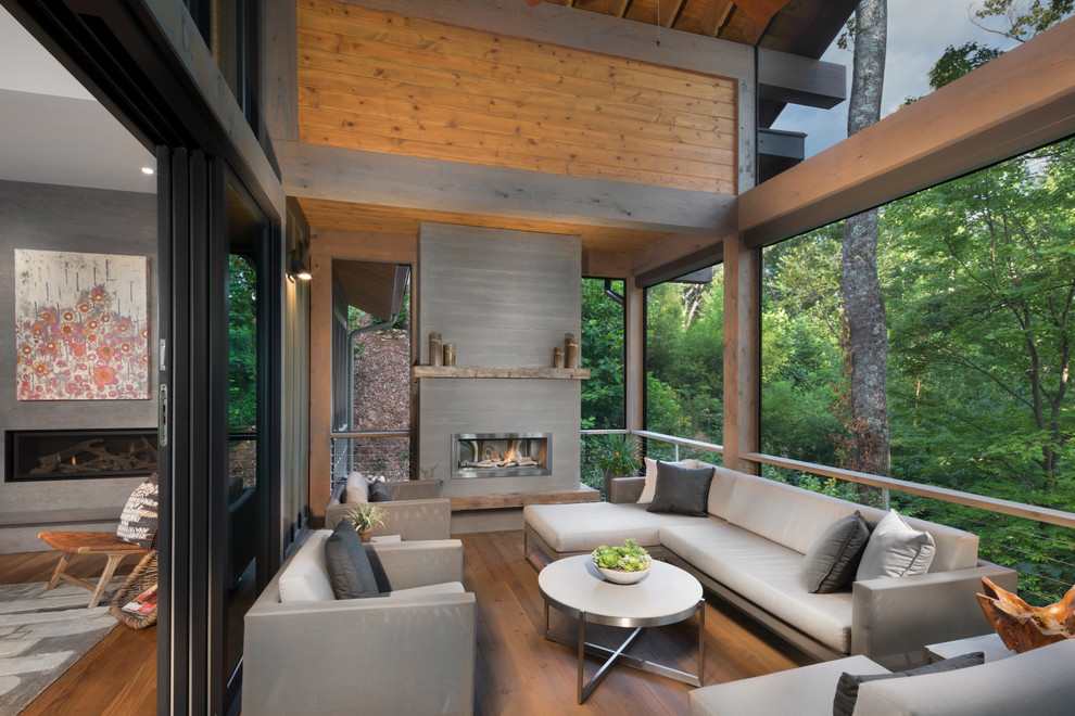 Inspiration pour une terrasse design avec un foyer extérieur et une extension de toiture.