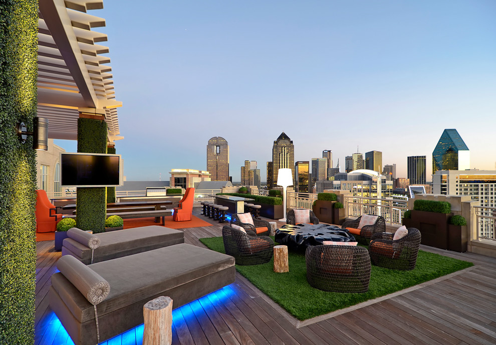 Example of a trendy deck design in Dallas with a fire pit and a pergola