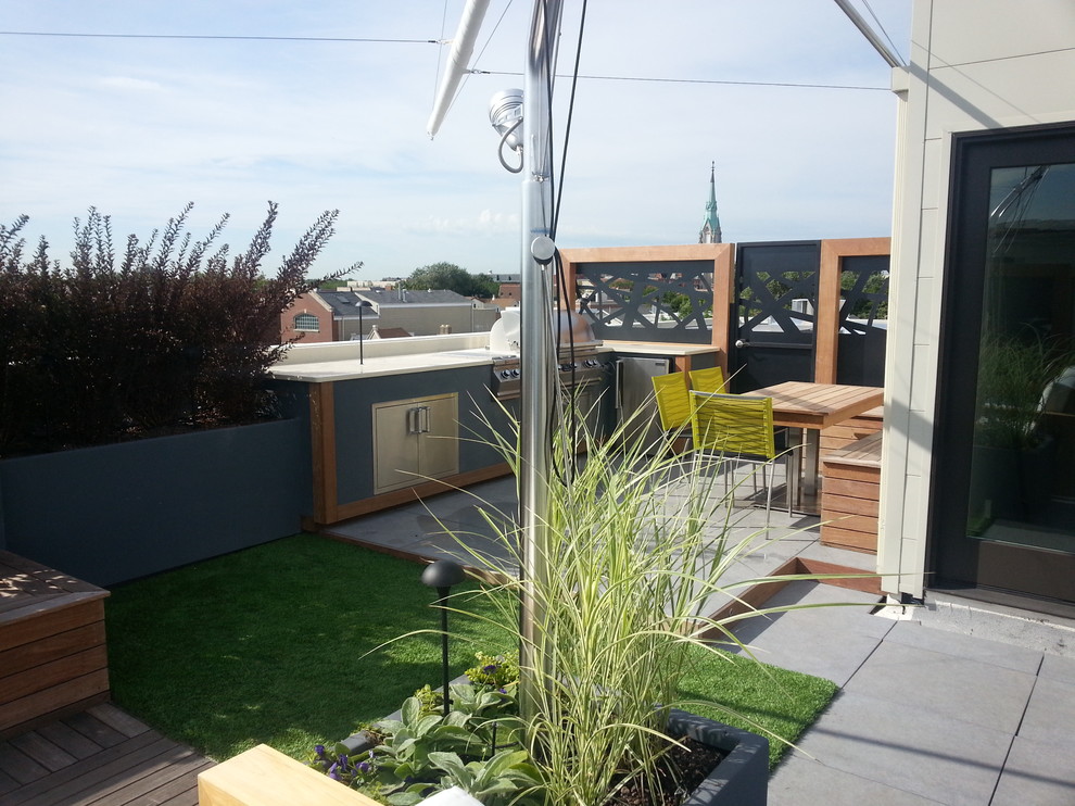 Inspiration pour une terrasse minimaliste avec une cuisine d'été et un auvent.