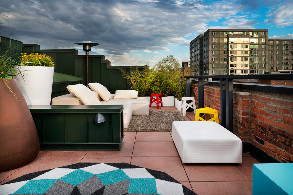This is an example of an industrial roof rooftop terrace in Denver with a potted garden and no cover.