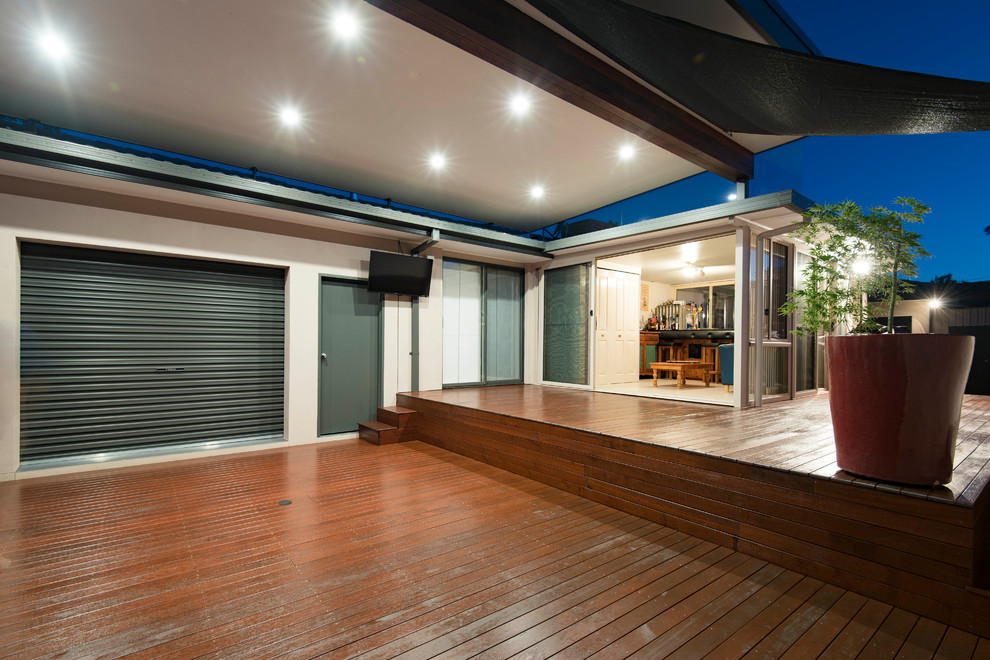 Example of a large trendy backyard deck design in Canberra - Queanbeyan with a pergola