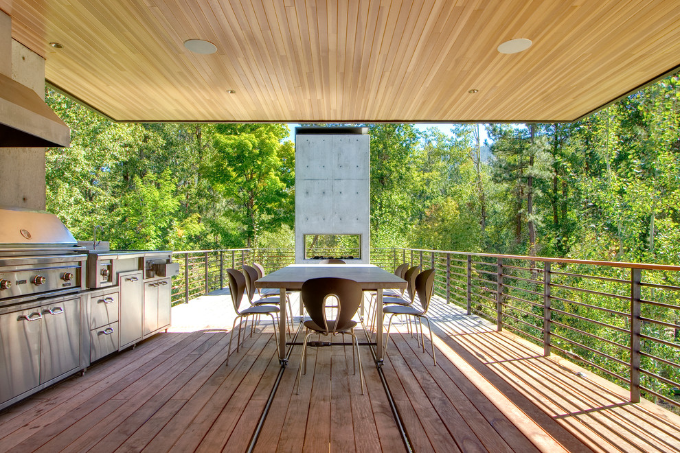 This is an example of a contemporary terrace in Seattle with an outdoor kitchen and a roof extension.