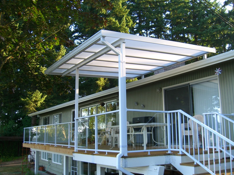 Example of a small classic backyard deck design in Seattle with an awning