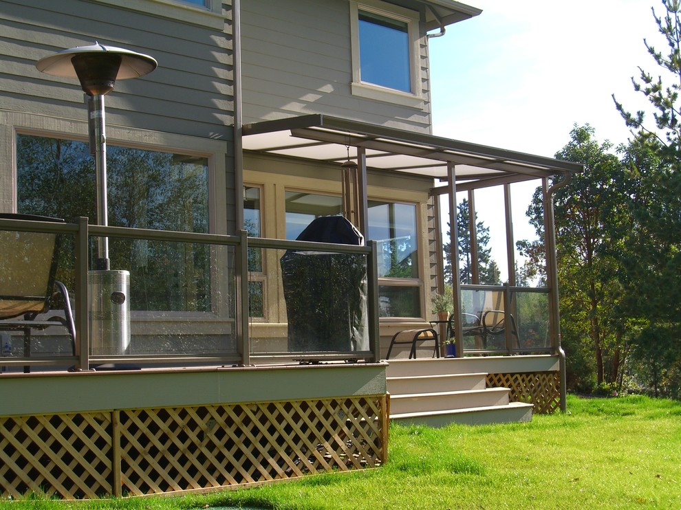 Inspiration for a small timeless backyard deck remodel in Seattle with an awning