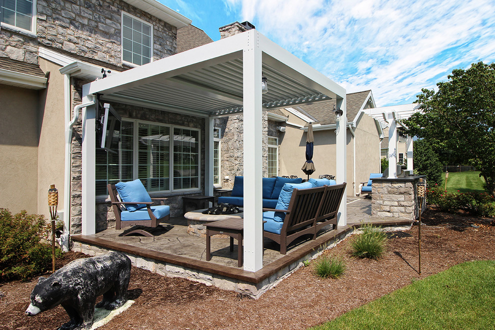 Example of a mid-sized cottage backyard deck design in Philadelphia with a fire pit and an awning