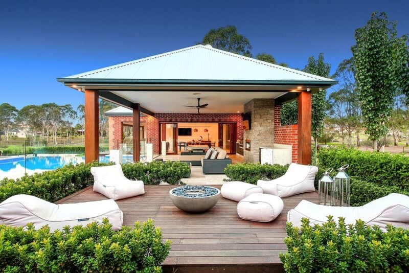 Inspiration for a large contemporary backyard outdoor kitchen deck remodel in Sydney with a roof extension