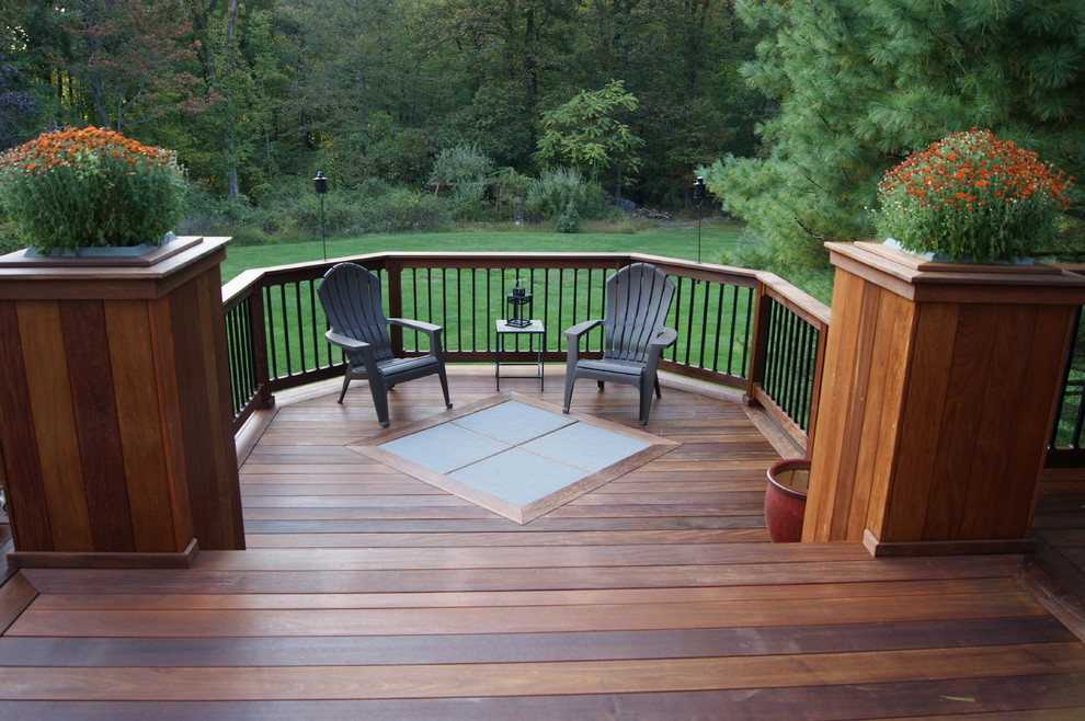 Example of a large classic backyard deck design in New York with a fire pit and a pergola