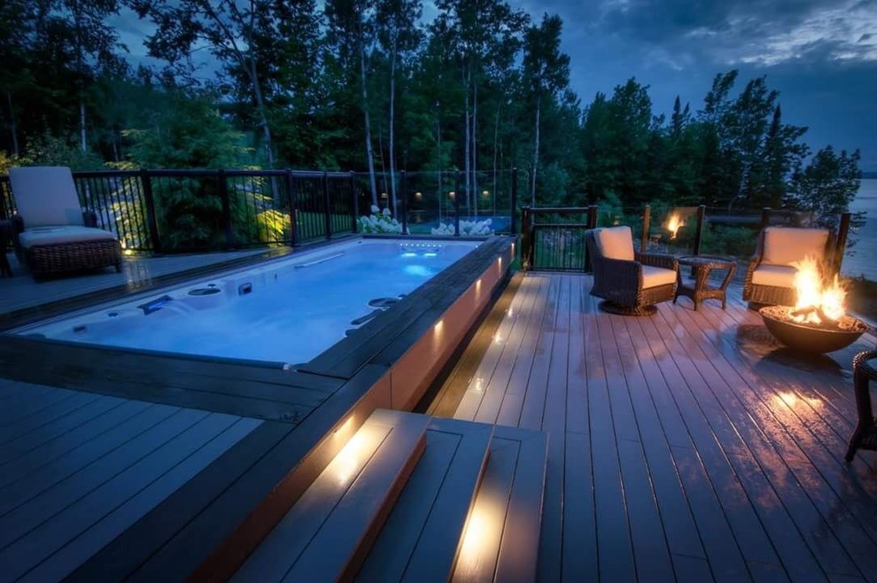 Inspiration for a large modern backyard deck remodel in Toronto with a fire pit and no cover