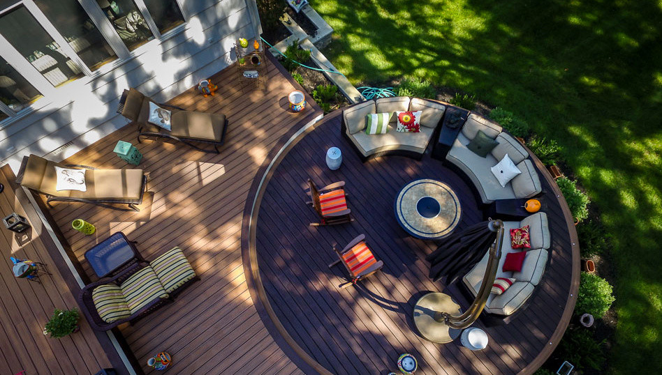 Inspiration for a large timeless backyard deck remodel in Newark with a fire pit and no cover